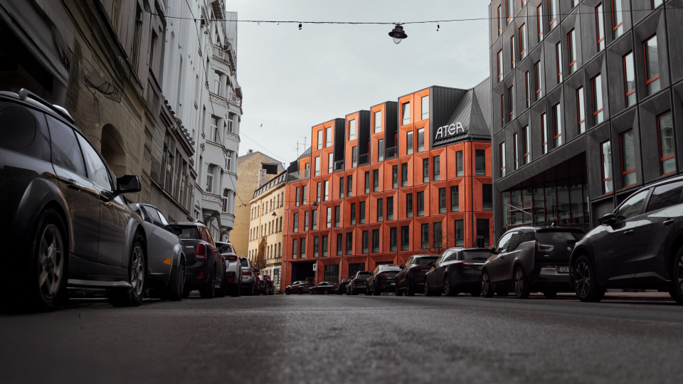Atea office building with a modern red exterior, viewed from the street.